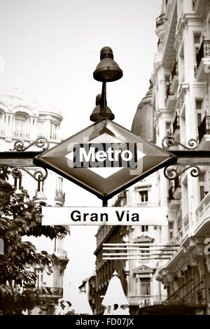 Metro sign in Madrid, Gran Via station. Black and white image, sepia toned. Stock Photo