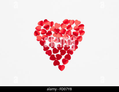 A heart shape on an isolated white background made from smaller heart shapes. Stock Photo