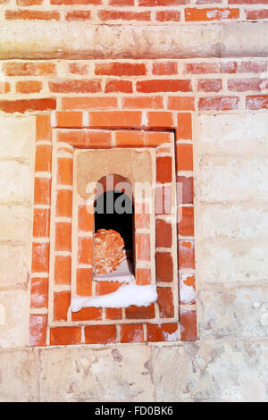 Small Windows in the fortress of red brick photographed close up Stock Photo