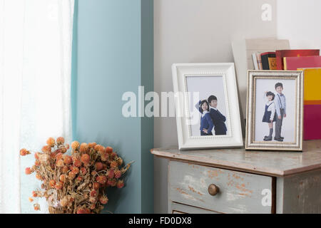 Children's photos in frames placed on a drawer Stock Photo