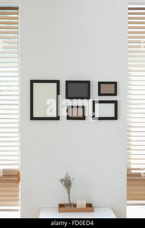Empty frames arranged on the white wall Stock Photo