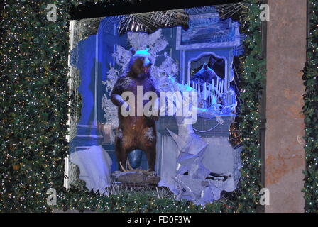 New York City - December 2015: Saks Fifth Avenue Christmas Window Display with a bear and a woman Stock Photo