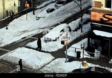 New York City:  Cars on West 143rd Street are plowed in with snow from the weekend January 23 blizzard Stock Photo