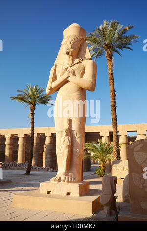 Karnak, Egypt - Statue of Pharaoh Ramses II with Queen Nefertari in the Great Courtyard, Amun-Re Temple Stock Photo
