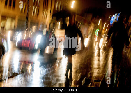 London, UK. 26th December 2016   A slow shutter speed with deliberate camera movement to illustrate Commuters walking in heavy rain on Buckingham Palace Road. Credit:  Chandra Prasad/Alamy Live News Stock Photo
