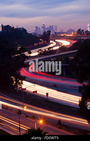 The 10 and 710 Freeway interchange seen from an aerial view and in the distance the Los Angeles skyline.  Los Angeles, Californi