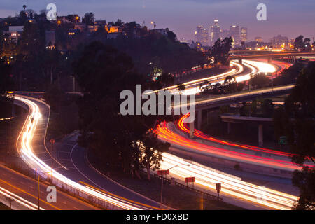 The 10 and 710 Freeway interchange seen from an aerial view and in the distance the Los Angeles skyline.  Los Angeles, Californi