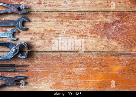 Older tools are laid out in a row on background of the old wooden floor Stock Photo