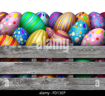 Easter egg hunt harvest as a group of decorated eggs in an old weathered wood crate box as a festive spring symbol for hunting holiday colorful painted oval gifts. Stock Photo