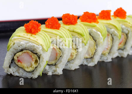 Maki Sushi with Salmon, red caviar on black tray. Selective focus Stock Photo