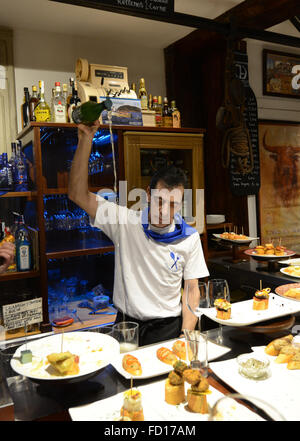 A Basque barman pouring traditional white wine called Txakoli in a traditional way. Stock Photo