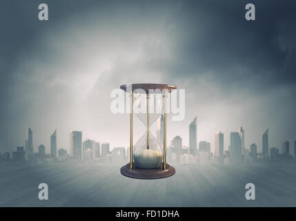 Conceptual image with huge sandglass. Time concept Stock Photo