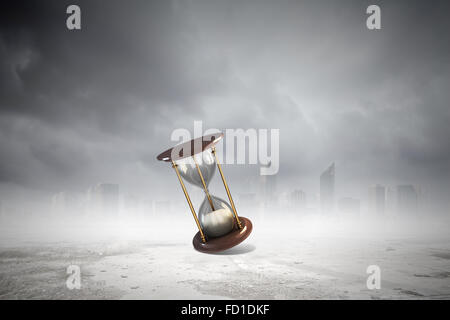 Conceptual image with huge sandglass. Time concept Stock Photo