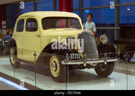 PRAGUE, CZECH REPUBLIC - AUGUST 28, 2015: Old refurbished retro car Skoda light yellow color is in the lounge at Prague airport Stock Photo