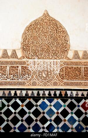 Tiles and wall carvings under the arches that lead into the Sala de los Embajadores in the Court of the Myrtles, Alhambra Palace Stock Photo
