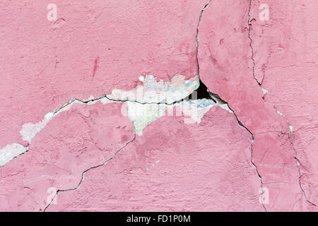 Abstract background concrete painted pink paint, weathered with cracks and scratches. Landscape style. Grungy Concrete Surface. Stock Photo
