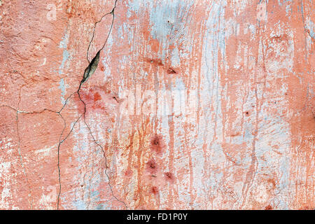 Abstract background concrete painted pink paint, weathered with cracks and scratches. Landscape style. Grungy Concrete Surface. Stock Photo