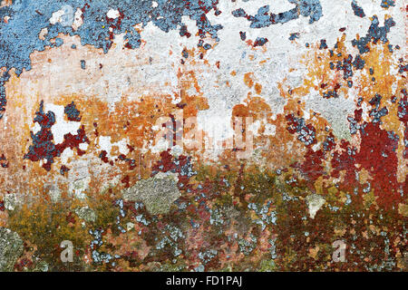 Abstract background concrete painted yellow, red, purple, blue paint, weathered with cracks and scratches. Landscape style. Grun Stock Photo