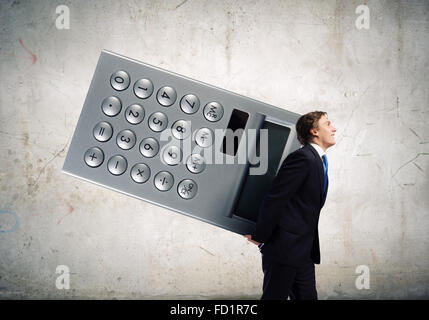 Young businessman carrying huge calculator in hands Stock Photo