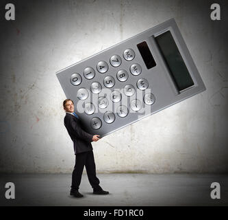 Young businessman carrying huge calculator in hands Stock Photo