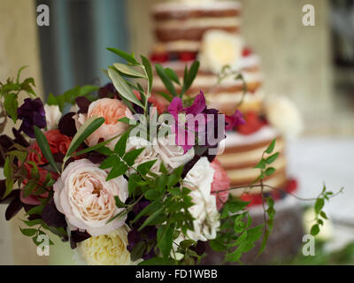 A luxurious wedding sponge cake with summer fruits and flowers Stock Photo