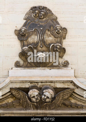 multiple cherub decoration above doorway in Cagliari, Italy Stock Photo