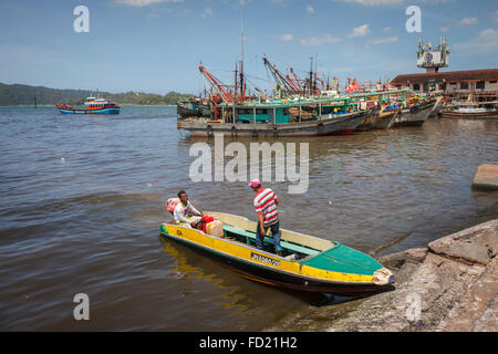 Boats on the shore of Kota Kinabalu, Sabah, Malaysia Borneo, with a small passenger vessel in the foreground. Stock Photo