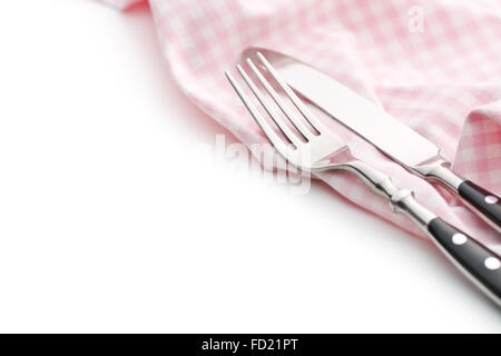 knife, fork and checkerd napkin on white background Stock Photo