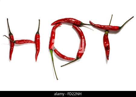 A group of red birds eye chillies on a white background spelling the word hot Stock Photo