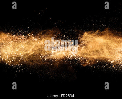 Explosion of orange powder, isolated on black background Stock Photo