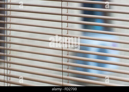 Venetian open blinds, close up image as background on the home window.  Opened  jalousie, gray alu metal shutters. Sunlight comi Stock Photo