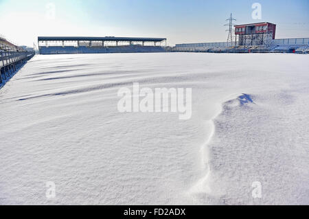 Empty tribunes and a football stadium covered in snow after a heavy snowfall Stock Photo