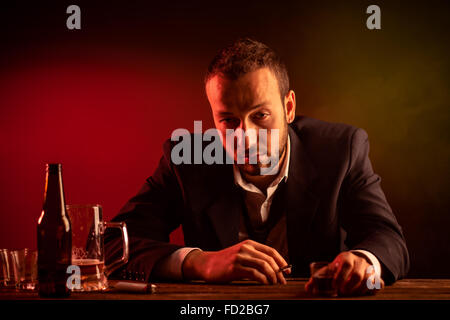 Businessman Smoking and Drinking in a Bar Stock Photo