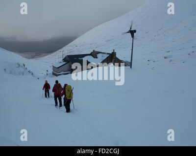 Mountaineers walk past the CIC mountaineering hut below the North Face of Ben Nevis near Fort William in the Scottish Highlands Stock Photo