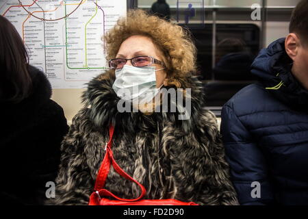 Moscow, Russia. 27th Jan, 2016. A woman wears face mask in fear of flu in metro of Moscow, Russia, on Jan. 27, 2016. Russia is facing the start of a flu epidemic, with most cases proved to be swine flu, the country's Reasearch Institute of Influenza warned recently. Credit:  Evegeny Sinitsyn/Xinhua/Alamy Live News Stock Photo
