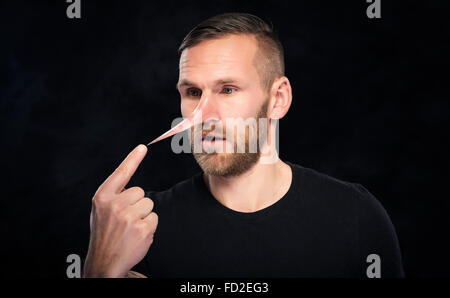 Man with a nose like Pinocchio. Stock Photo