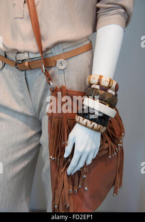 Leather bag,bracelets and belt on trousers Stock Photo