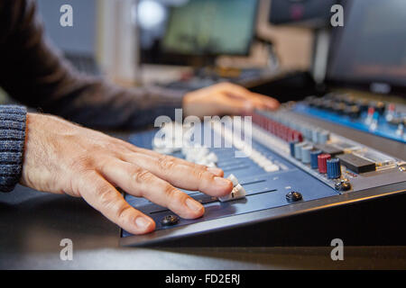 Sound manager is working on a new mix of a song. Stock Photo