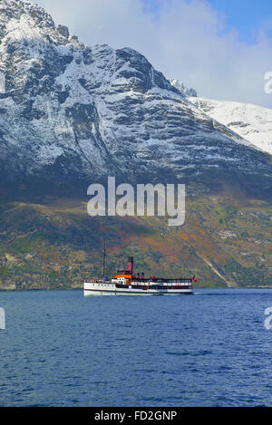 The TSS Earnslaw at 1912 Edwardian steamer cruising the waters of Lake Wakatipu with snow covered mountains in the background Queenstown, New Zealand Stock Photo