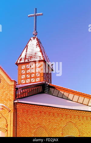 Beautiful Catholic Church photographed closeup on a background of blue sky Stock Photo