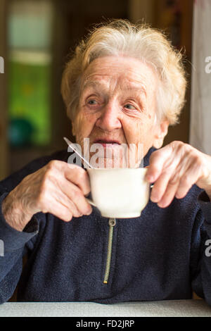 Portrait of an elderly woman drinking tea. Stock Photo