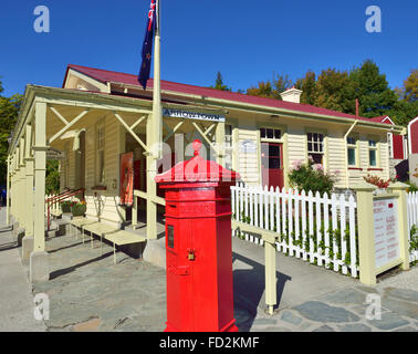 A red letter box in front The Old Post Office in the Main street Arrow Town , Otago region of the South Island of New Zealand. Stock Photo