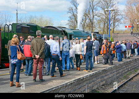 Group of enthusiast railway people & preserved engine 34046 Braunton hauling steam train at Banbury station during water stop Oxfordshire England UK Stock Photo