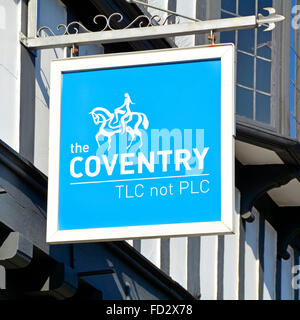 Sign above 'The Coventry Building Society' branch premises in Stratford upon Avon includes slogan 'TLC not PLC' and Lady Godiva Stock Photo