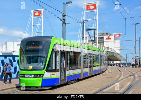 Croydon tramlink service operated by FirstGroup tram approaching East Croydon British Rail train railway interchange station South London England UK Stock Photo