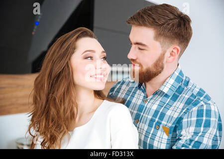 Portrait of a happy young couple looking at each other at home Stock Photo