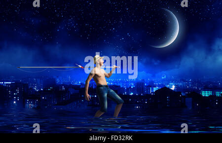 Young boy at night with fishing rod Stock Photo