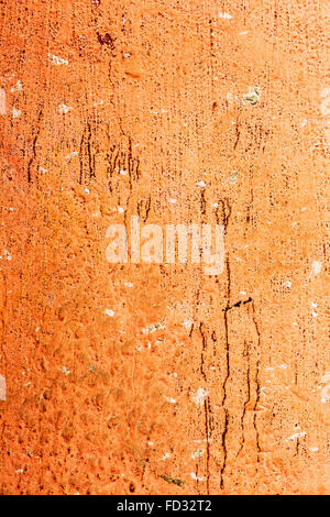 Creative background old concrete wall paint orange paint, stains water stains, cracks and scratches. Grungy concrete surface. Gr Stock Photo