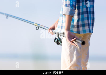 Close-up Of Hands Of A Boy With A Fishing Rod That Is Fishing On The 