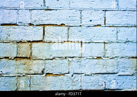 A weathered blue brick wall as a detailed background Stock Photo